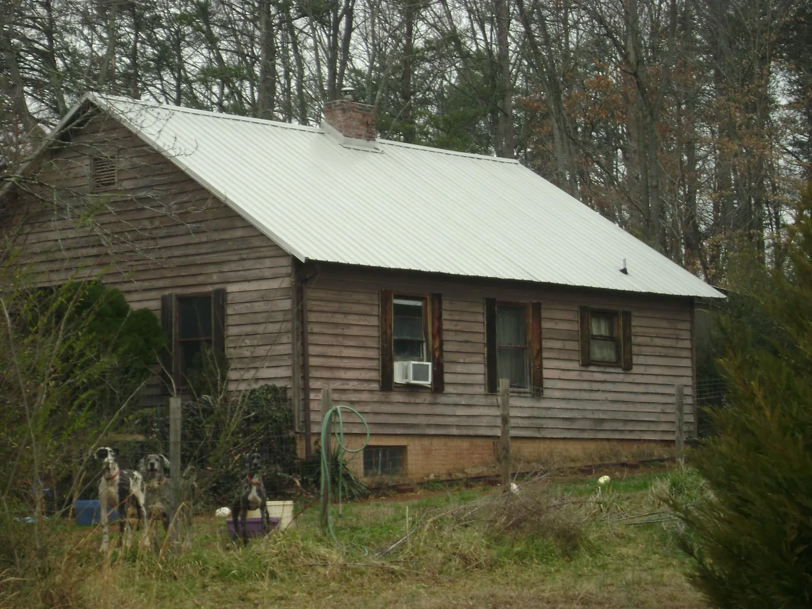 White metal roof on an old wood sided farmhouse, from a Metal Roof Installation job in Old Station